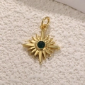 Golden starburst pendant with a green gemstone center on a white textured background - Green Stone Star