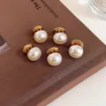 Five elegant white pearl brooches with gold base on a textured brown vintage book - Style 1 - Pearl Short Pin (5 Pcs)
