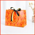 Luxury red gift bag with vintage gold patterns and black ribbon bow handle - Red (Green & Black Ribbon)