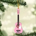 Detailed view of pink acrylic guitar ornament with Mark lettering on a Christmas tree - Pink
