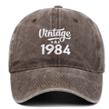 Detail of Vintage 1984 white embroidery on a washed charcoal grey cotton baseball cap - Adjustable / Coffee