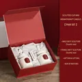 Wedding scented candle gift box featuring white bust sculptures and red packaging - Bluebell + Freesia Wedding Edition