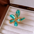 Detail of vintage flower ring with blue-green enamel petals in a jewelry display box - 12# Ring - Gold - Green Enamel