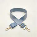 Detail of light blue nylon bag strap with polished gold-tone metal buckles and lobster clasps - Light Blue