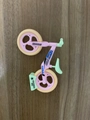 Pink and mint green toy balance bike model with movable wheels on a wooden surface - Large / Orange Tire