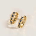Detail view of gold-plated geometric hoop earrings with deep blue trapezoid stones - Royal Blue