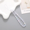 Iridescent star beaded phone strap accessory on a white wave ceramic tray display - White Mermaid Star (K523)