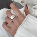Elegant silver wide band ring with bead edges on a hand holding a glass - Wide Band Beaded Edge