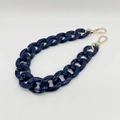 Close-up of dark blue marble acrylic handbag chain strap with gold metal lobster clasps - 37cm / Dark Blue White