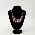 Gold Halloween charm necklace with pumpkin, ghost and spider charms on black neck display - Halloween Necklace