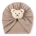 Close-up of khaki knit baby turban hat with a cute beige plush bear ornament - One Size / Coffee
