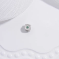 Detailed close-up of a silver barrel bead with green gemstone floral accents for jewelry - Silver with Green Rhinestone Flower Spacer Bead