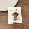 Set of lace brown bow and floral fabric hair clips on a card display - Oval + Flower