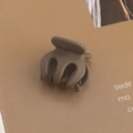 Detail view of small dark grey matte hair claw clip on brown textured background - 2# Matte Morandi Grey