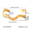 Detail of 18k gold wave bangle showing star engraving and cubic zirconia inlay - Wave Star Engraved Open Bangle (HC-B20352)