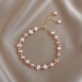 Baroque pink freshwater pearl bracelet with adjustable gold chain on beige silk fabric - Pink Freshwater Pearl Style