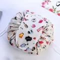 Portable drawstring makeup bag in cream with hand-drawn cosmetic pattern and velcro flap - Flowery Years
