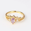 Macro detail of 18K gold ring with purple pear-shaped zircon and leaf crown design - Purple Pear Crown Gold Style (Style 11 Gold)