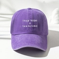 Detail of washed purple cotton cap with THICK THIGHS X THIN PATIENCE white embroidery - One Size / Purple