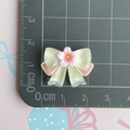 Detailed view of transparent resin bow charm with pink cherry blossom for DIY hair clips - Transparent Sakura Bow / Yellow