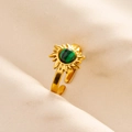 Detailed shot of golden sun-shaped ring with green malachite gemstone and adjustable band - Gold-Green Malachite