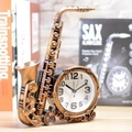 Vintage saxophone shaped alarm clock with antique bronze finish on a wooden table - Bronze Saxophone Alarm Clock