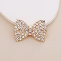 Detailed view of golden bow accessory with sparkling rhinestones and colorful crystals - D1985 White Rhinestone Bow (Gold Base)