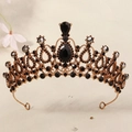 Macro detail of golden crown featuring black gemstones and intricate metal textures - Gold/Teardrop Black Stone