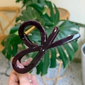 Detail of dark burgundy acetate shark hair claw clip with golden metal spring - Dark Red