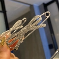 Macro view of a crystal bow-shaped brooch pin with sparkling rhinestones and alloy base - Full Rhinestone Bowknot Style (Silver)