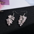 Detailed close-up of handmade pink quartz crystal tassel earrings on silver hooks - Silver Hook Style / Rose Quartz Color