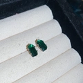 Close-up of emerald-cut green cubic zirconia earrings in silver prong settings - Small / Green