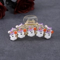 Ghost hair claw with purple witch hats and orange candies on grey textured background - 11cm Candy Ghost Champagne Base