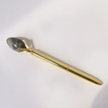 Detail showing creative golden metal ballpoint pen with a natural gemstone top accent - Dragon Blood Stone