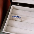 Detailed macro view of an elegant crown-shaped silver ring with deep blue sapphire zircon stones - Crown Lace Blue Zirconia Style