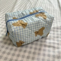 Gesteppte Kosmetiktasche mit blau-gelbem Karomuster und braunem Bärenmotiv - Blauer Bär