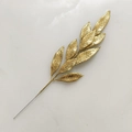 Macro detail of golden glitter leaf pick for Christmas floral decoration and DIY crafts - Gold
