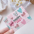 Pink and white striped Happy Birthday card with glittery hearts held by hand - Birthday Heart