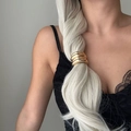 Close-up of a stylish gold metal bow hair tie worn on a ponytail by a model - Smooth Layered Style Gold