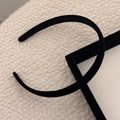 Elegant thin black sponge headband displayed on a soft white faux fur background - Black 1.5cm