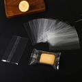 Clear food-grade plastic packaging bags for snacks and cookies on a dark background - 4.5x7.5cm