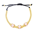 Detail of pink enamel evil eye charms on adjustable gold beaded drawstring bracelet - Pink