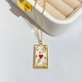 Detail of The Lovers tarot pendant necklace featuring white enamel and a red heart - LOVERS
