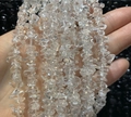 Handheld display of irregular clear quartz crystal chips on a minimalist beaded necklace - Bracelet / White Crystal