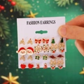 12 pairs of Christmas stud earrings featuring Santa, reindeer, and snowflakes on a white card - 09 Earrings (12 Pairs Set)