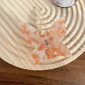 Elegant orange butterfly hair claw clip with colorful acetate marble pattern on wooden tray - 6.5cm / Crystal Orange