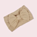 Detail of cable knit pattern and large bow on beige nylon infant headband - Light Coffee
