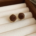 Detail of vintage gold-rimmed round earrings with dark brown flocking on a beige display - Round Style (HE29253) / Brown