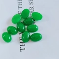 Ten pieces of oval green jade cabochons for jewelry making on a white background - 6*8mm / Malay Jade