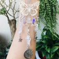 Detailed shot of silver butterfly suncatcher with crystal beads and sun moon pendants - Synthetic Clear Quartz